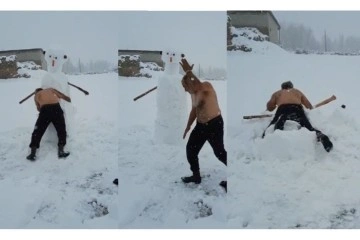 Dondurucu soğukta soyundu, kardan adamla güreş tuttu